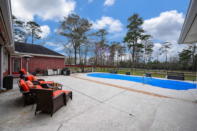 view of swimming pool featuring a fenced in pool, a patio, and a fenced backyard