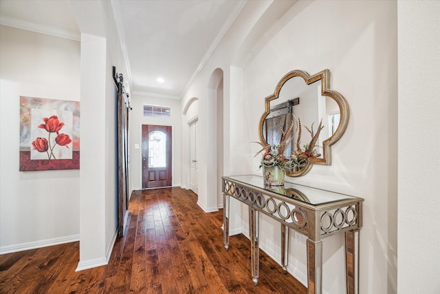 interior space featuring visible vents, baseboards, ornamental molding, hardwood / wood-style floors, and arched walkways