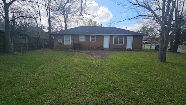 back of house with a lawn, central AC, and fence