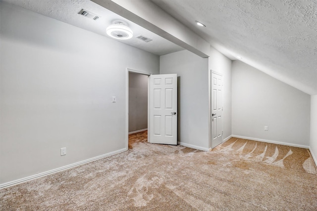 bonus room with visible vents, baseboards, vaulted ceiling, carpet flooring, and a textured ceiling