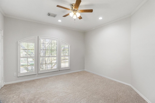 spare room featuring visible vents, crown molding, carpet, and a ceiling fan