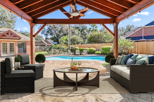 view of patio / terrace with a fenced in pool, an outdoor hangout area, a fenced backyard, and a ceiling fan