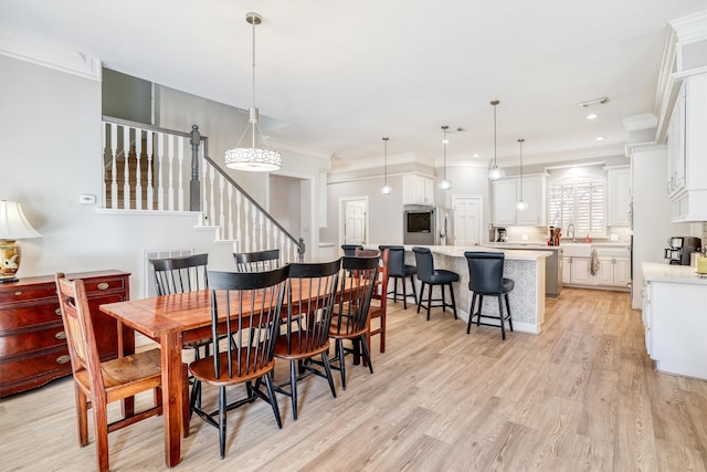 dining area with crown molding, stairway, recessed lighting, and light wood-type flooring