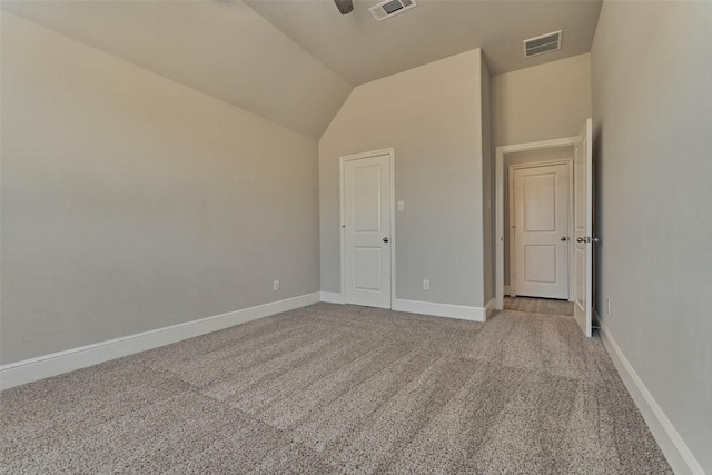 interior space featuring vaulted ceiling, visible vents, baseboards, and carpet floors