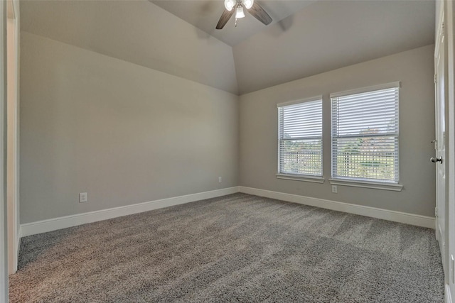 empty room with baseboards, lofted ceiling, carpet, and ceiling fan