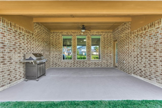 view of patio with area for grilling and ceiling fan