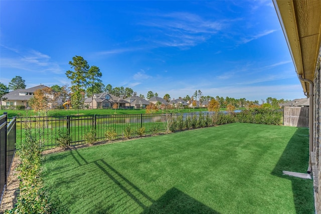 view of yard featuring a residential view and a fenced backyard