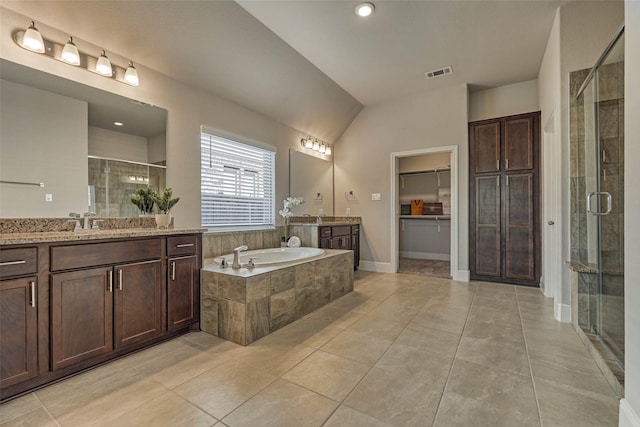 bathroom featuring visible vents, a stall shower, a sink, tile patterned flooring, and a bath