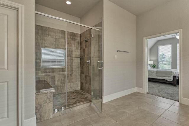 ensuite bathroom featuring baseboards, ensuite bath, a stall shower, ceiling fan, and tile patterned flooring