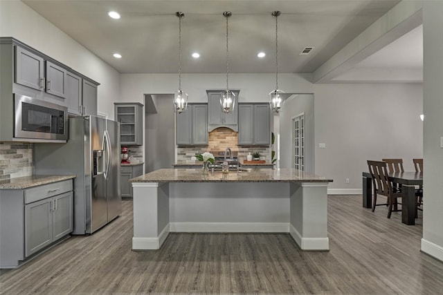 kitchen with visible vents, gray cabinets, stainless steel appliances, and a sink