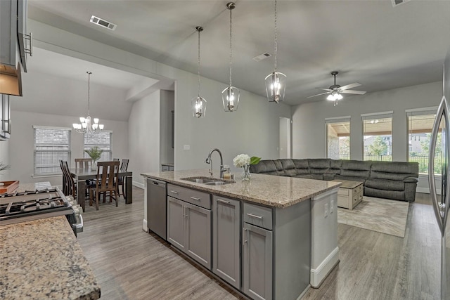 kitchen featuring visible vents, gray cabinetry, a sink, light wood-style floors, and dishwasher