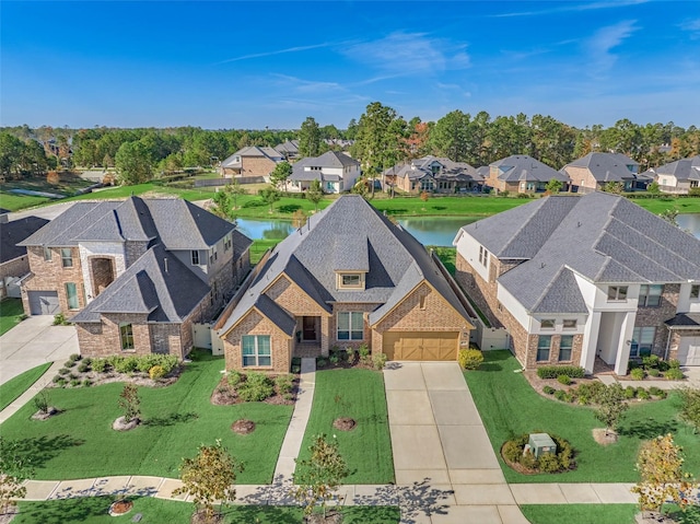 birds eye view of property with a residential view and a water view