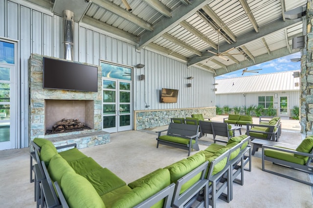 view of patio featuring french doors and an outdoor living space with a fireplace