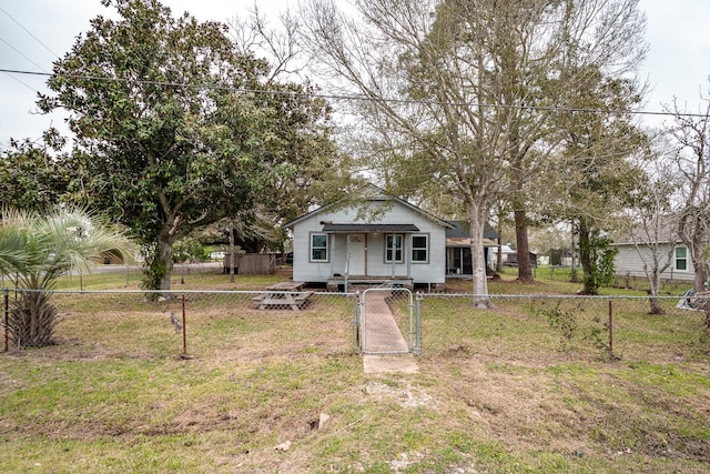 bungalow-style house featuring a front yard, a gate, and a fenced front yard