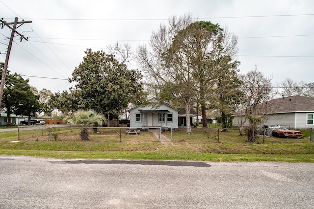 view of front of house with a fenced front yard, a front yard, and a gate