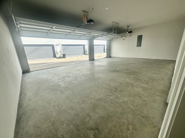 garage featuring electric panel and a garage door opener