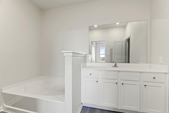 bathroom featuring a bath and vanity