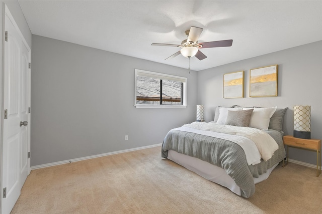 bedroom with baseboards, a ceiling fan, and carpet flooring