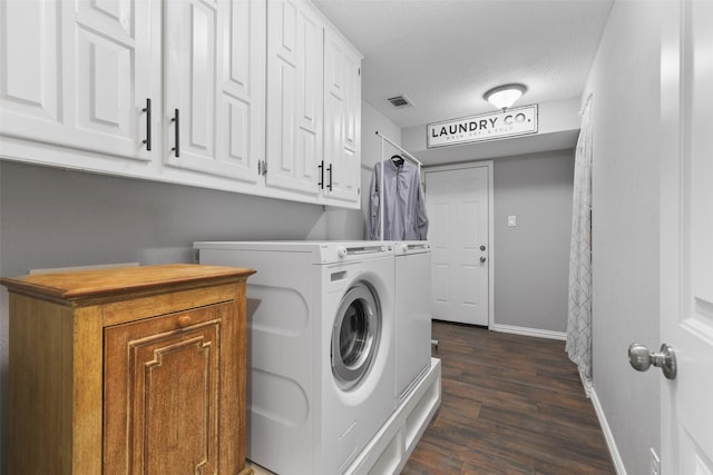 laundry room with visible vents, dark wood-type flooring, washer and dryer, cabinet space, and baseboards