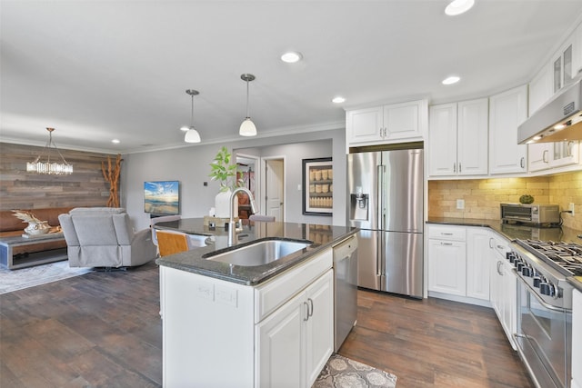 kitchen featuring dark wood-style floors, a sink, decorative backsplash, stainless steel appliances, and crown molding