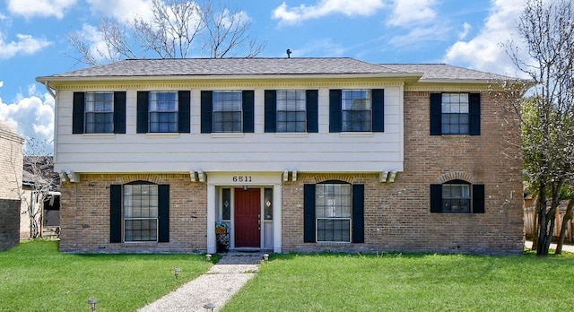 6511 Las Brisas Dr, Houston, TX 77083 - colonial inspired home featuring brick siding and a front lawn