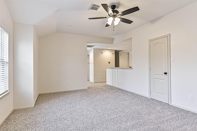 empty room featuring light carpet, visible vents, baseboards, and a ceiling fan