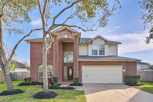 traditional-style home featuring a front lawn, concrete driveway, a garage, and fence