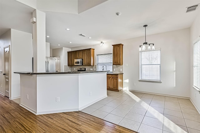 kitchen with visible vents, a healthy amount of sunlight, and appliances with stainless steel finishes