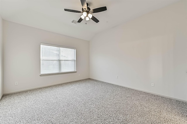 empty room featuring visible vents, baseboards, lofted ceiling, carpet flooring, and a ceiling fan