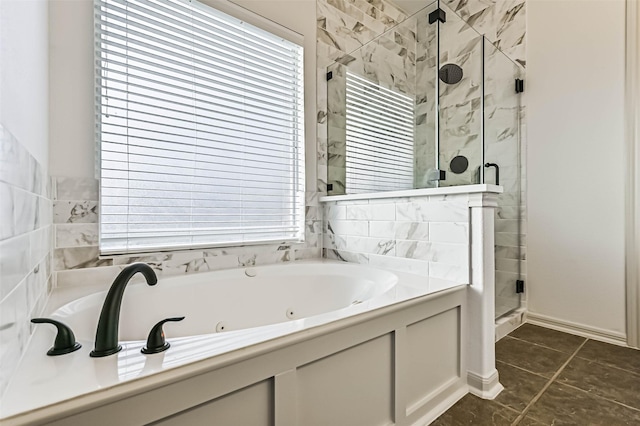 full bath with a shower stall and a whirlpool tub