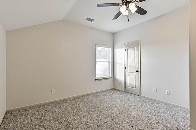 spare room with visible vents, baseboards, light colored carpet, lofted ceiling, and a ceiling fan