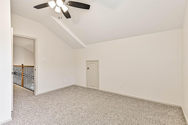 carpeted spare room featuring ceiling fan, baseboards, and lofted ceiling