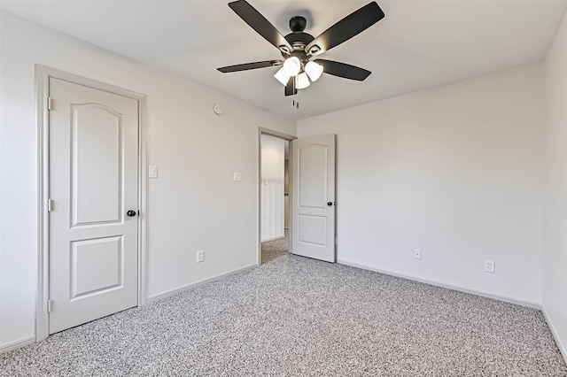 unfurnished bedroom with light carpet, a ceiling fan, and baseboards