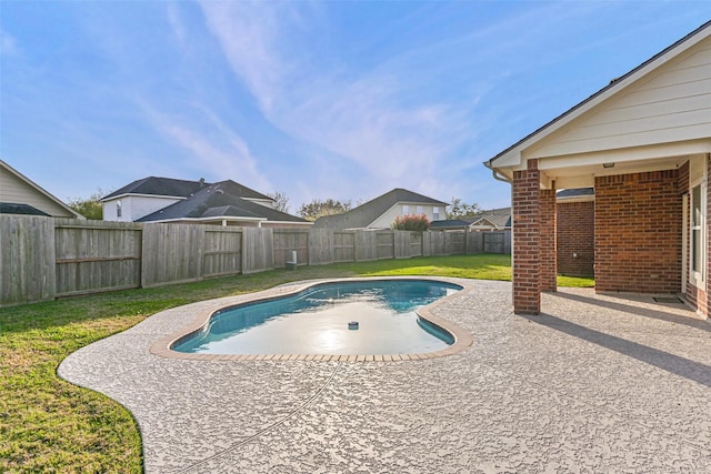 view of pool featuring a patio, a lawn, a fenced in pool, and a fenced backyard