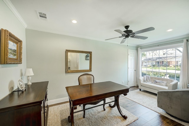 office area with visible vents, ornamental molding, wood finished floors, baseboards, and ceiling fan