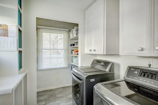 laundry room with washer and clothes dryer, cabinet space, and baseboards