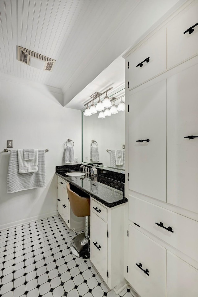 bathroom featuring tile patterned floors, visible vents, vanity, and crown molding