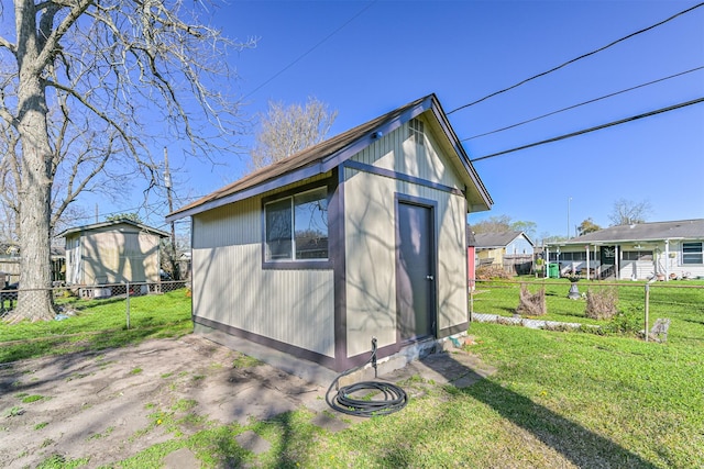 view of shed featuring fence