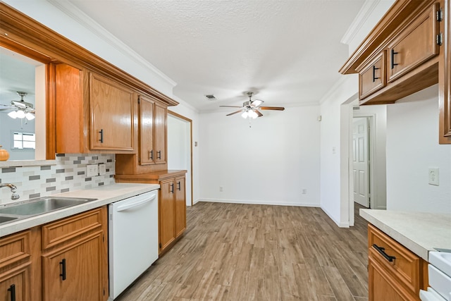 kitchen featuring dishwasher, crown molding, light countertops, and ceiling fan