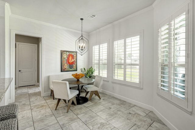 dining space with a notable chandelier, baseboards, visible vents, and ornamental molding