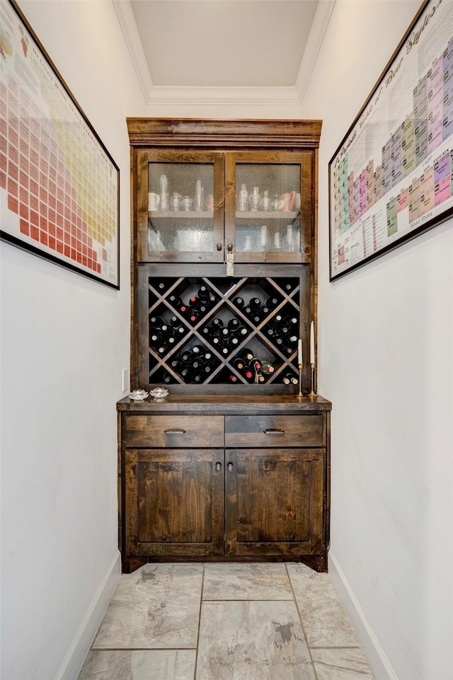 wine room featuring baseboards and ornamental molding