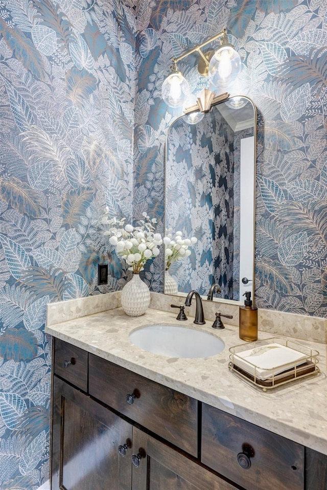 bathroom featuring wallpapered walls and vanity