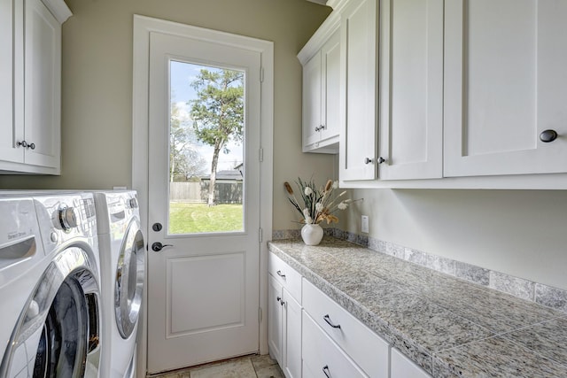 washroom featuring washer and dryer and cabinet space