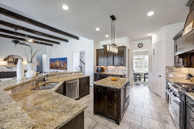 kitchen featuring dark brown cabinets, a center island, stainless steel appliances, a ceiling fan, and a sink