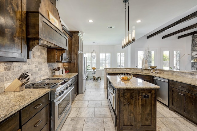 kitchen with dark brown cabinets, visible vents, backsplash, and stainless steel appliances