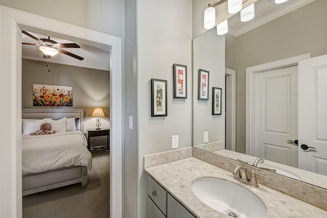 bathroom with ensuite bath, vanity, ceiling fan, and ornamental molding