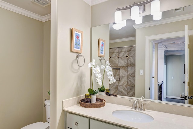 bathroom featuring visible vents, toilet, vanity, and ornamental molding