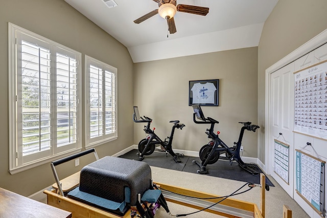 exercise area with visible vents, ceiling fan, baseboards, and vaulted ceiling