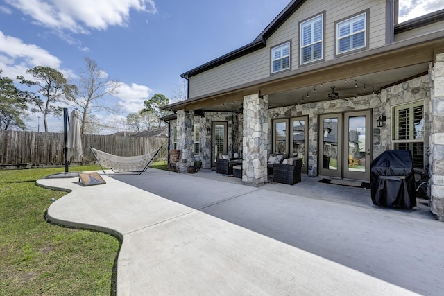 view of patio / terrace with french doors, an outdoor hangout area, a grill, and fence