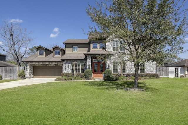 view of front facade featuring a front lawn, fence, a garage, stone siding, and driveway